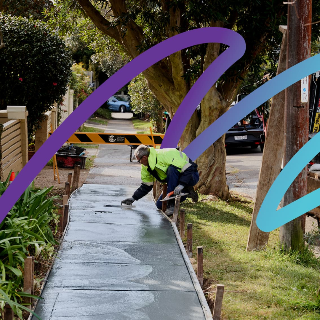 A council worker smoothing the concrete on a newly poured footpath. There is a decorative ribbon across the image.