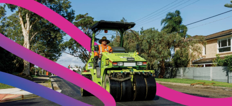 Roller flattening newly laid road sheeting - decorative ribbon digitally added to the image