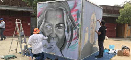 People painting a cube