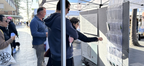 people looking at information on noticeboard