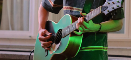 Close up of a teenager playing guitar