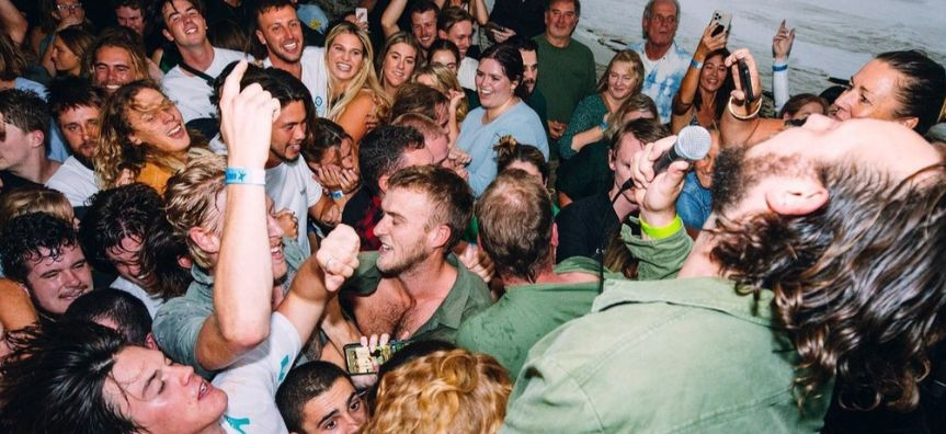 Photo of a live music gig, people dancing and loving the music. 