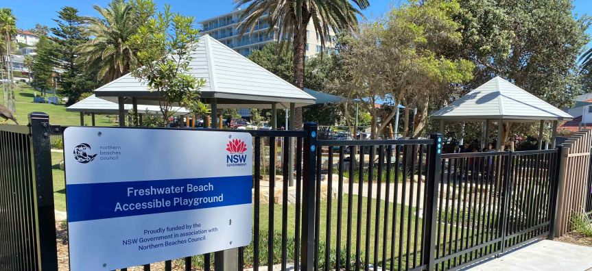 Sign and fencing outside playground 