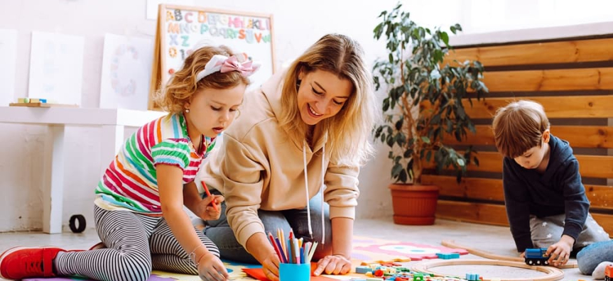 two young kids playing with an adult