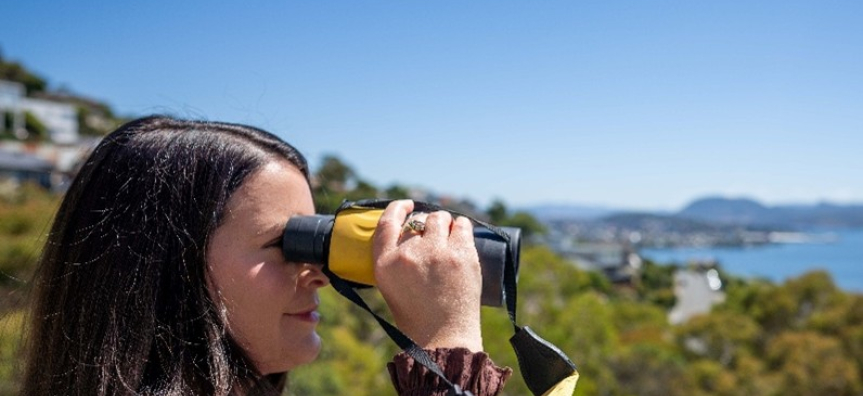 Photo of a lady looking with binoculars