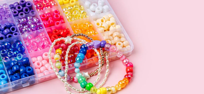 beads and bracelets on a pink background