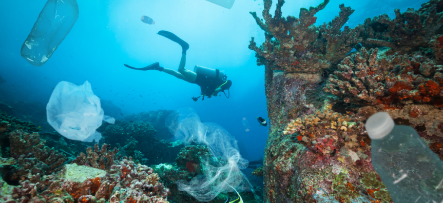 diver in ocean with plastic