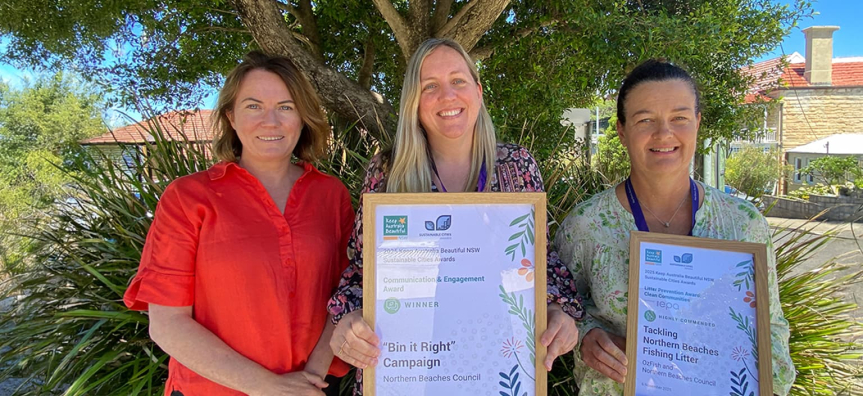 Three people holding their certificates for the Sustainable Cities Awards