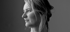 Close up portrait of Kate Butcher, a blond woman, looking to the left with high contrast lighting