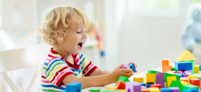 Young child playing with colourful blocks
