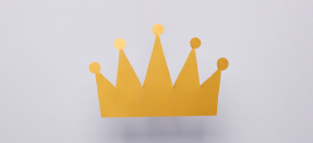 A gold crown on a grey background