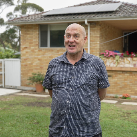 Person standing in front of their house